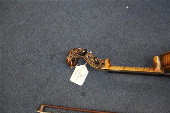 A decorative violin, bearing Gaspar da Salo label, body 14.5in., overall 23.5in., cased with a bow